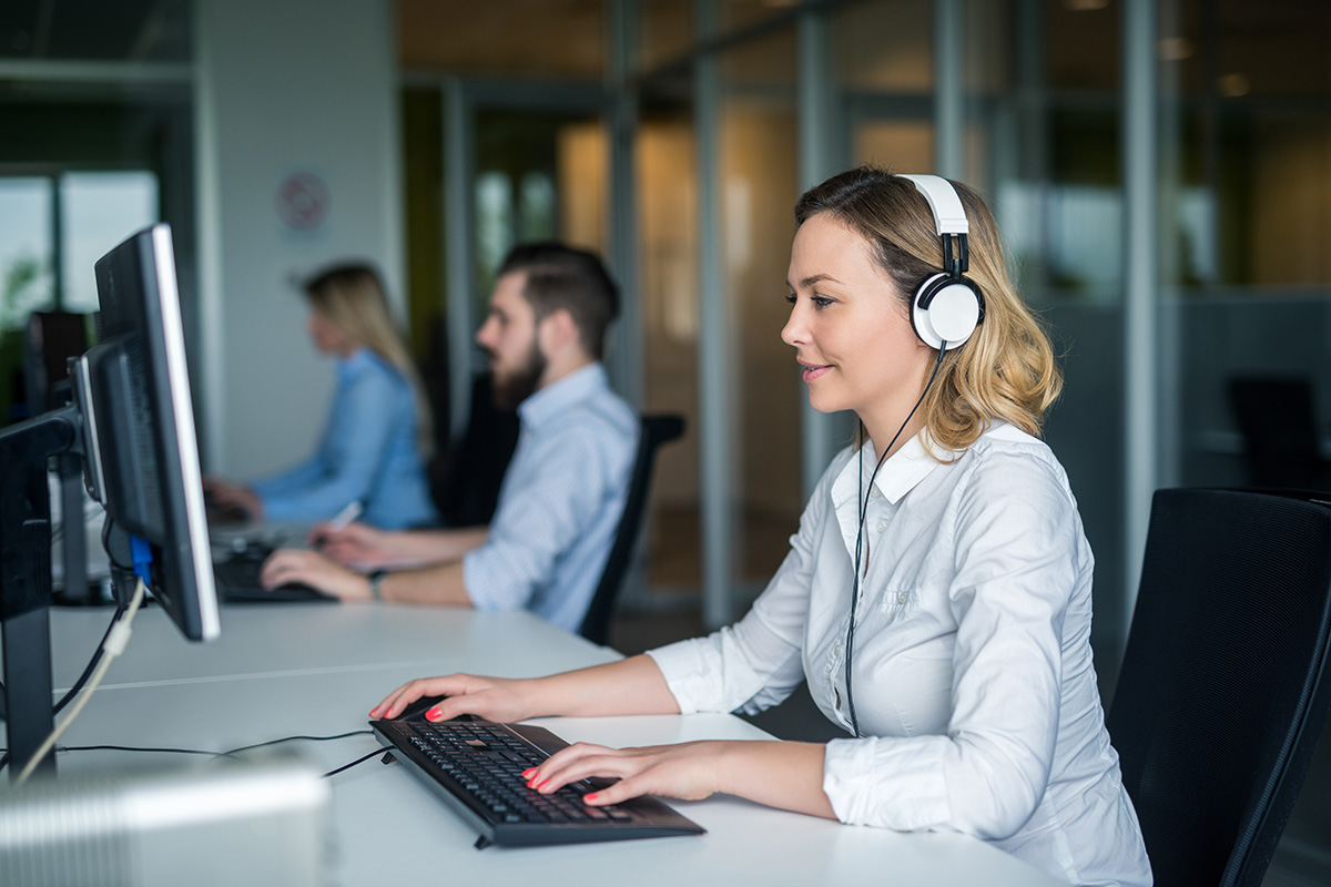 Team of people wearing headsets in the office